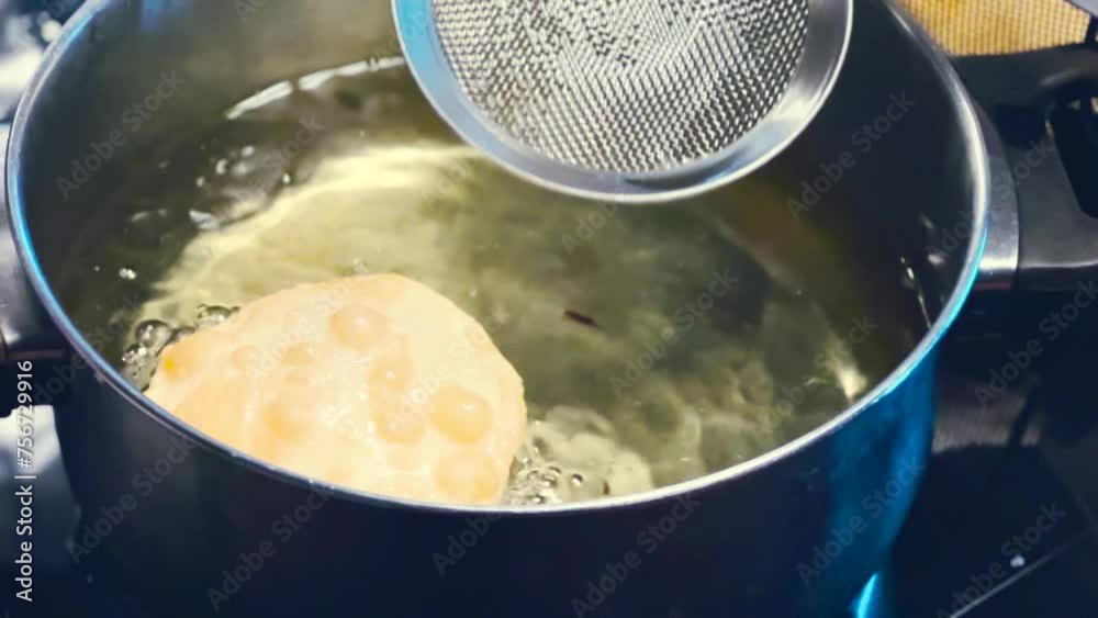 Close up shot of Indian puri fried bread being fried in oil. Fried bread preparation in Indian street in morning time. 4k. Vegetable dish. Indian Dish or Cuisine