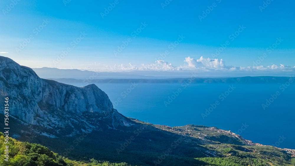 Fototapeta premium Panoramic aerial view of the Makarska Riviera seen from skywalk in Biokovo nature park, Dalmatia, Croatia. Majestic karst coastline of Adriatic Mediterranean sea in summer. Tranquil serene atmosphere