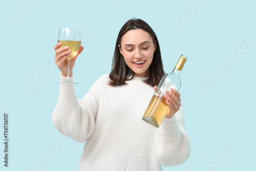 Happy young woman holding w...