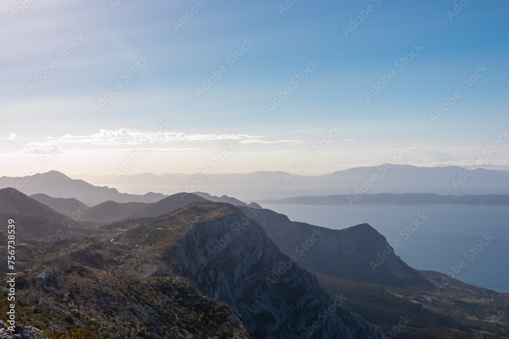 Obraz premium Panoramic aerial view of the Makarska Riviera seen from skywalk in Biokovo nature park, Dalmatia, Croatia. Majestic karst coastline of Adriatic Mediterranean sea in summer. Tranquil serene atmosphere