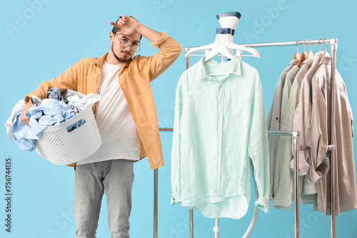 Tired young man with modern...