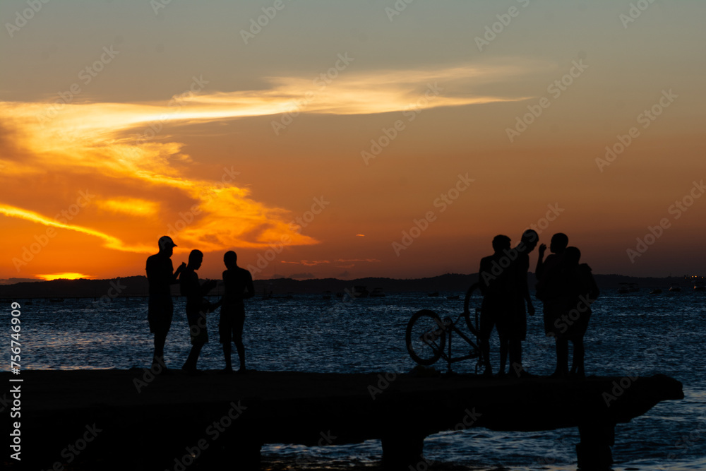 Young people, in silhouette, are seen together, enjoying the sunset from the top of the Crush bridge in the city of Salvador, Bahia.