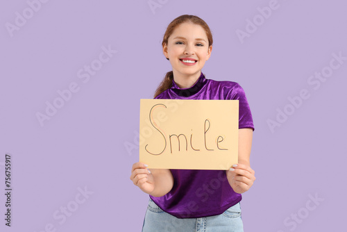 Young redhead woman holding...