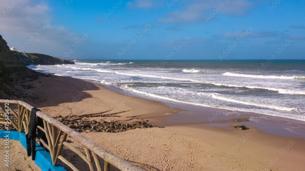 Panoramic view of paradise golden sand beach of coastal village Ericeira, Portugal, Europe. Looking at majestic Atlantic Ocean. Serene tranquil vacation atmosphere. Empty tropical landscape in summer