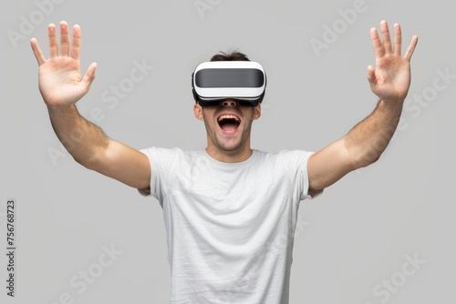 A man with raised hands wearing a virtual reality headset, seemingly enjoying an immersive experience. Technology and entertainment with virtual reality headset