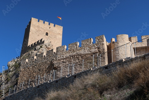 Sax, Alicante, Spain, March 12, 2024: Wall and tower of the Almohad castle of Sax on top of a rock. Sax, Alicante, Spain photo