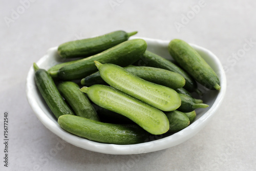 Fresh mini cucumbers in bowl
