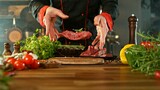 Chef Throwing Raw Beef Steak on Wooden Cutting Board.