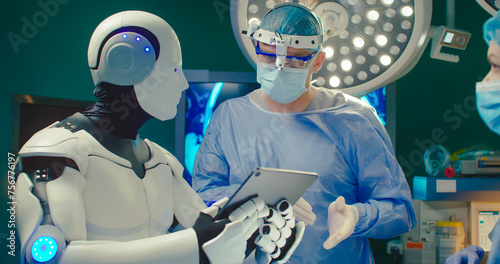 Obraz na plátně Close up portrait Robot holding digital tablet helps doctor to perform surgical operation in modern hospital