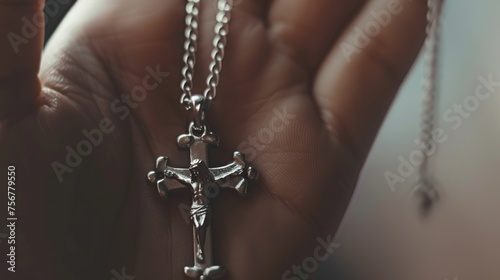 hand holding a Jesus Christ cross necklace