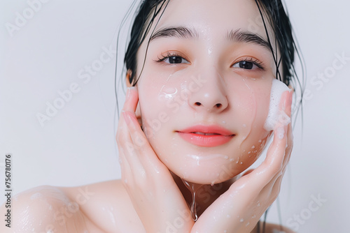 Asian girl with clean skin washes, white background