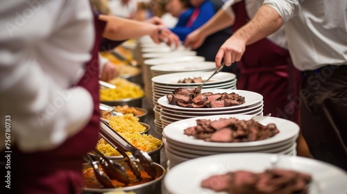 a group of people standing around a buffet line with plates of food on each side of the buffet line and plates of food on the other side of the buffet line. photo