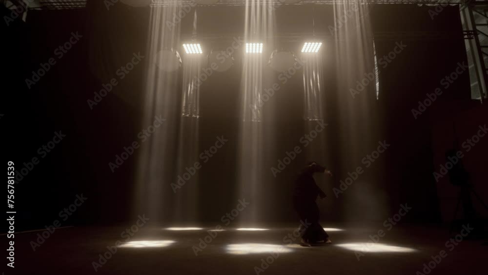 Enchanting Dance Of A Woman Amidst Warm Studio Lights