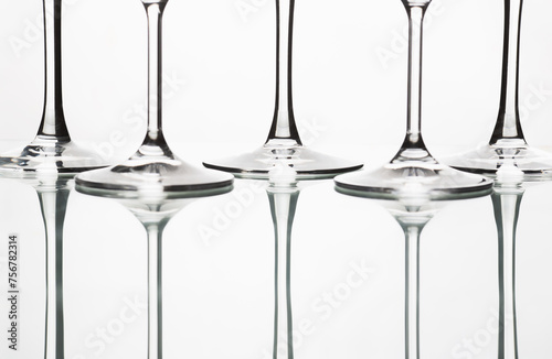 Isolated wine glasses on white. Abstraction from the glasses.. Beautiful table setting with restaurant utensils in various combinations in an interesting, creative design on a light background.