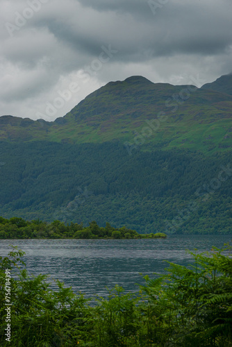 Overcast skies over a mountain and calm flowing river in Scottish Highlands