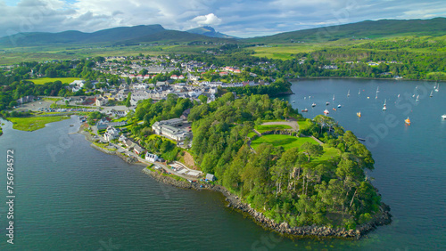 AERIAL: Picturesque seaside town with harbour on the Isle of Skye on a sunny day
