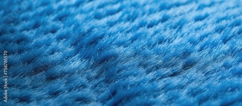 Artificial blue textile carpet texture background with selective focus and blur.