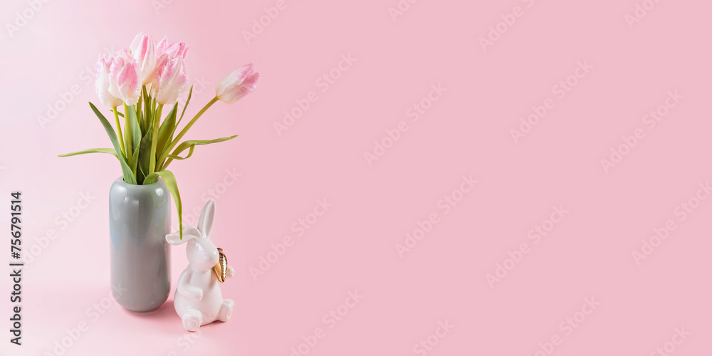 Pink tulips in vase and white Easter bunny figurine on pastel pink background Pink tulips in vase and white Easter bunny figurine on pastel pink background