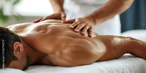 Male therapist massages patients lower back to relieve pain in clinic. Concept Therapeutic Massage, Lower Back Pain Relief, Male Therapist, Clinic Setting, Patient Care