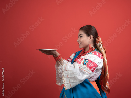 Hispanic girl of Kichwa origin with a red background and holding a plaque to place an object. photo