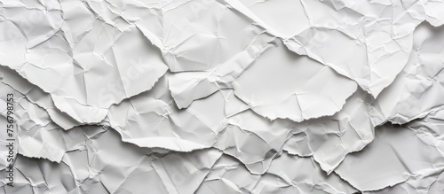 A close up of a crumpled white paper on a grey rectangular wood flooring with a monochrome pattern. Monochrome photography captures the texture of the paper event