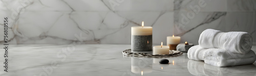 Beautiful composition with spa stones, bath towels on white marble table. Background with copy space