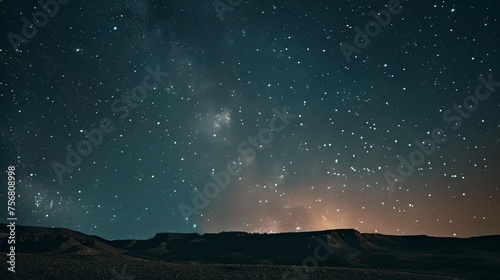 A stunning long exposure shot of the night sky over a desert landscape, showcasing the beauty of the cosmos