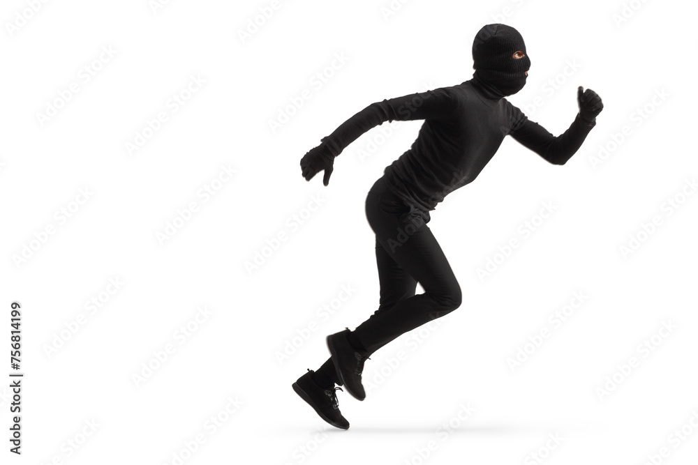 Full length profile shot of a thief in black clothes and balaclava running