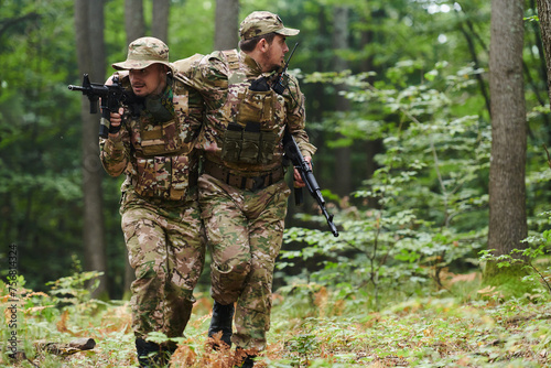 Elite soldier displays unwavering camaraderie and compassion as he aids his injured comrade, skillfully extracting him from the forest with a stretcher, showcasing the profound bond and selflessness