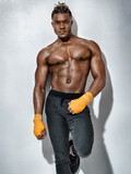 Photo of handsome man with perfect body after training on gray background. Strength and motivation
