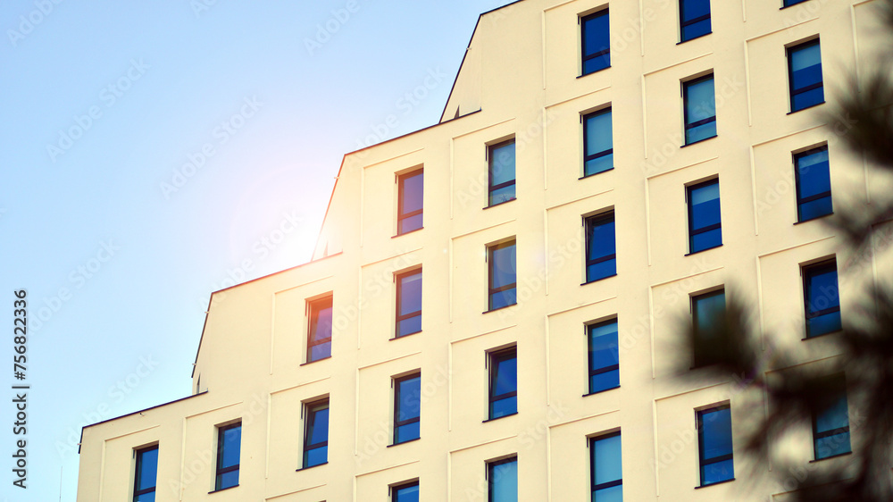 View of a white modern apartment building. Perfect symmetry with blue sky. Geometric architecture detail modern concrete structure building. Abstract concrete architecture. View of a white modern apartment building. Perfect symmetry with blue sky. Geometric architecture detail modern concrete structure building. Abstract concrete architecture.
