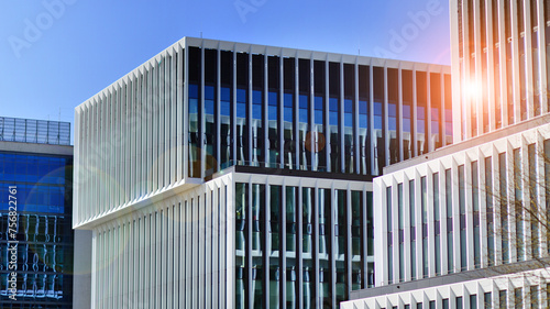 Modern office building in the city with windows and steel and aluminum panels wall. Contemporary commercial architecture, vertical converging geometric lines.
