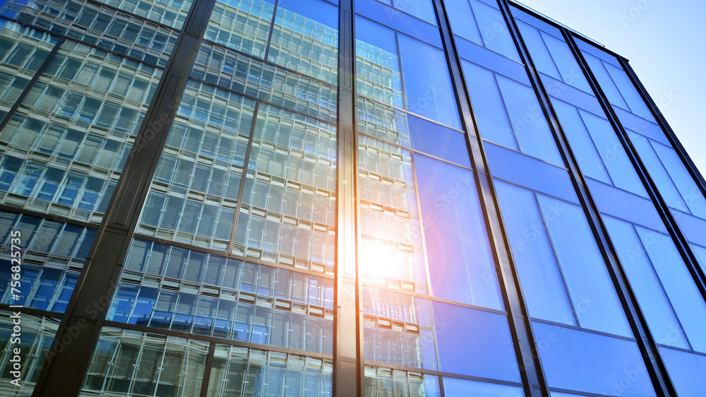 Obraz premium Modern office building with glass facade. Transparent glass wall of office building. Reflection of the blue sky on the facade of the building.