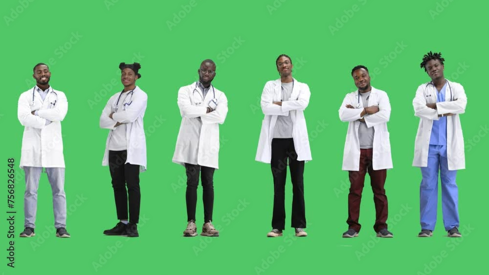 A group of doctors, on a green background, in full height, crossed their arms
