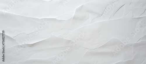 A close up of a piece of grey paper, resembling a snowcovered slope with cumulus clouds. The pattern and font are reminiscent of monochrome photography