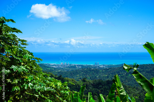 Fototapeta Naklejka Na Ścianę i Meble -  Tranquil Puerto Rico Seascape, Luquillo City Skyline, and Cloudy Horizon over the Carribean Ocean, a view from Yokahu Observation Tower in El Yunque National Forest Tropical Park