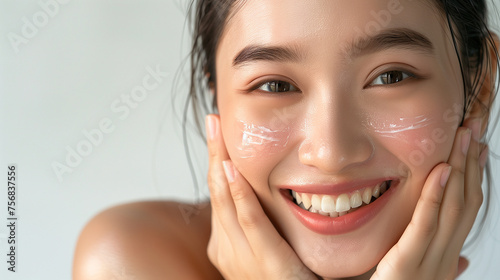 Beautiful Japanese woman in her 20s doing skin care  clear white skin and glossy lips  close-up                                        
