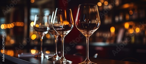 An exquisite display of stemware with wine glasses adorning a table perfect for serving alcoholic beverages like wine or champagne photo