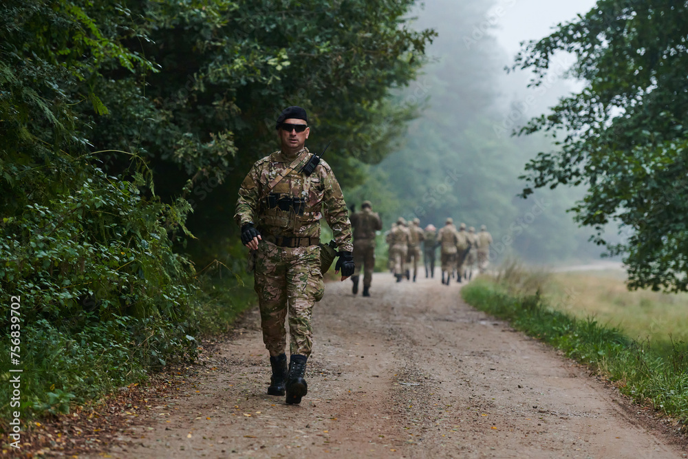 A group of elite soldiers leads captives through a military camp, showcasing a tense atmosphere of detention and security operations A group of elite soldiers leads captives through a military camp, showcasing a tense atmosphere of detention and security operations