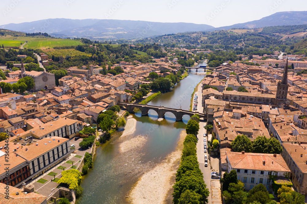 Picturesque drone view of Limoux summer cityscape looking out over ghotic cathedral on bank of river Aude , France. - obrazy, fototapety, plakaty 