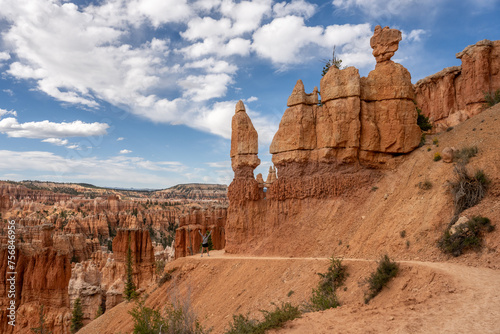 Woman Stands with Excitement at Curve of Trail in Bryce © kellyvandellen
