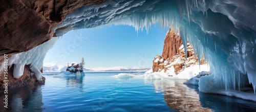 Gazing out from inside the ice cave, the azure sky reflected on the frozen lakes liquid surface, creating an electric blue world in the natural landscape © 2rogan