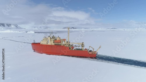 Antarctic Icebreaker Ship Float Ice Aerial View Shot. Laurence M. Gould Research Boat Float Through Southern Ocean Frozen Glacier on Mountain Landscape Top Tracking Drone View