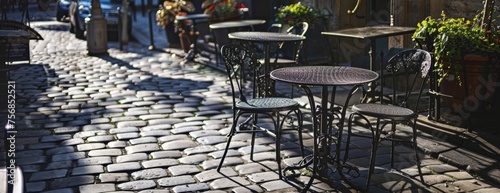 Sun-drenched Parisian cafe terrace, shadows of wrought iron furniture on cobblestone, copy space