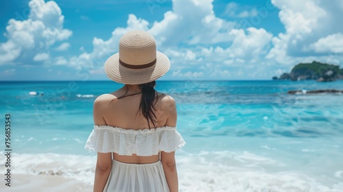 Back view young happiness asian traveller woman in white dress and hat standing on beautiful sandy beach. Cute girl enjoy her tropical sea on relax holiday vacation during summer time and sunshine day