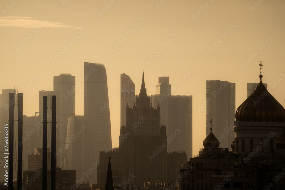 Downtown cityscape of Moscow City district at golden sunset. Buildings silhouette