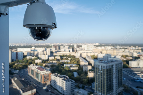 CCTV camera video control at the roof of building watching at cityscape