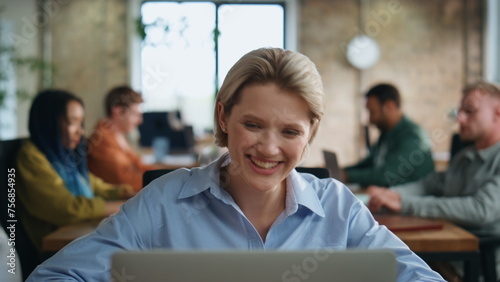 Businesswoman smiling video conference sitting office with business team closeup