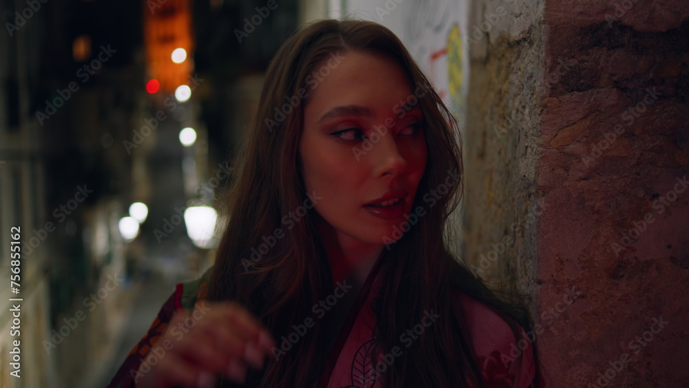 Gorgeous model standing urban street late evening looking camera close up. Gorgeous model standing urban street late evening looking camera close up.