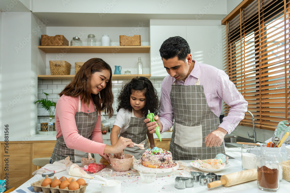 Asian attractive couple making cake with daughter in kitchen at house. Asian attractive couple making cake with daughter in kitchen at house.